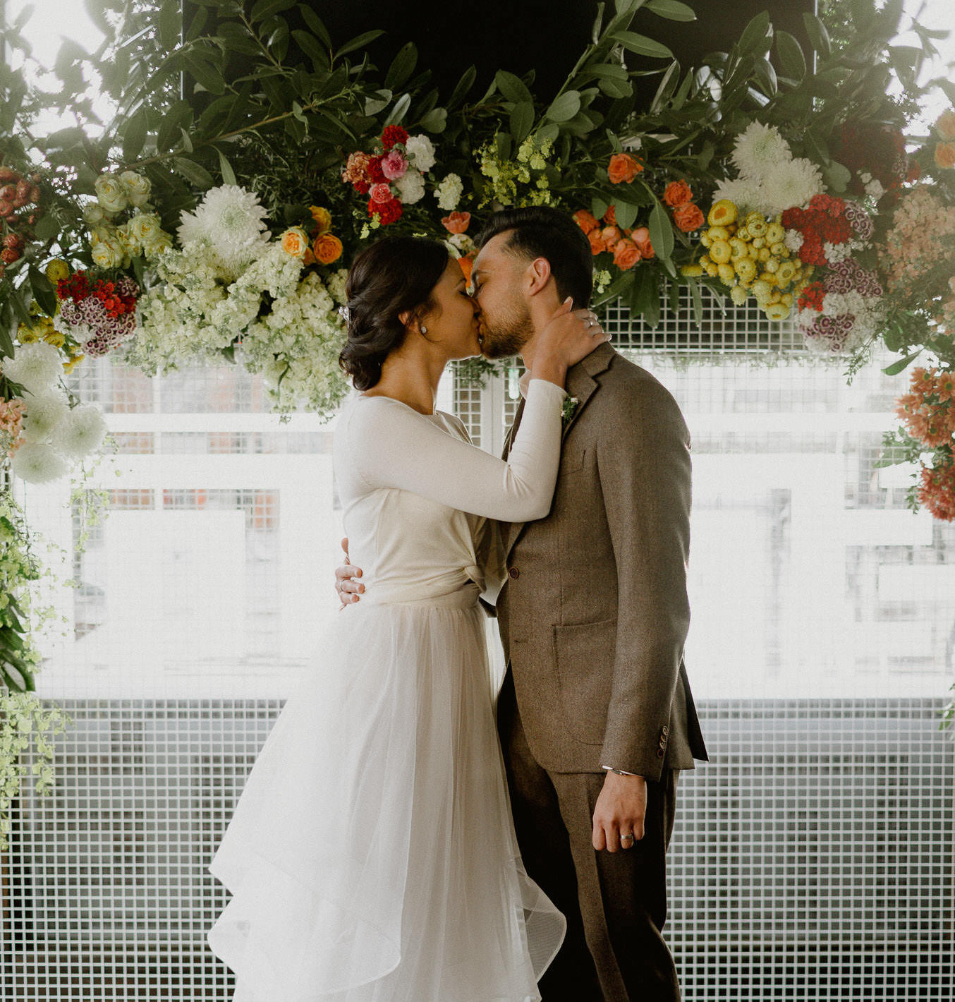Close up floral ceremony backdrop detail Studio Green white mesh backdrop flowers